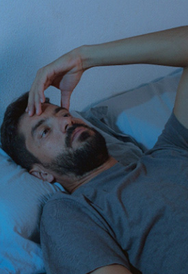 Closeup of man lying awake in bed