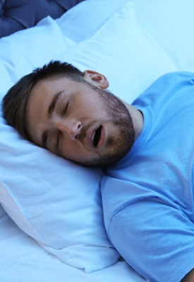 Man snoring while sleeping in bed
