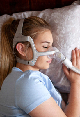 Woman sleeping with CPAP machine