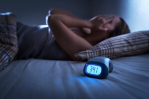 Woman experiencing sleepless night.