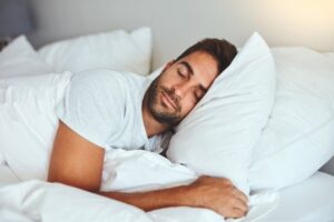 Man sleeping with weighted blanket