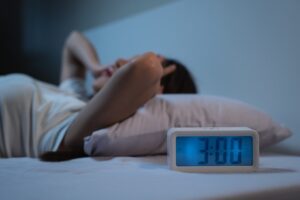 Person suffering from sleeplessness in the middle of the night. 